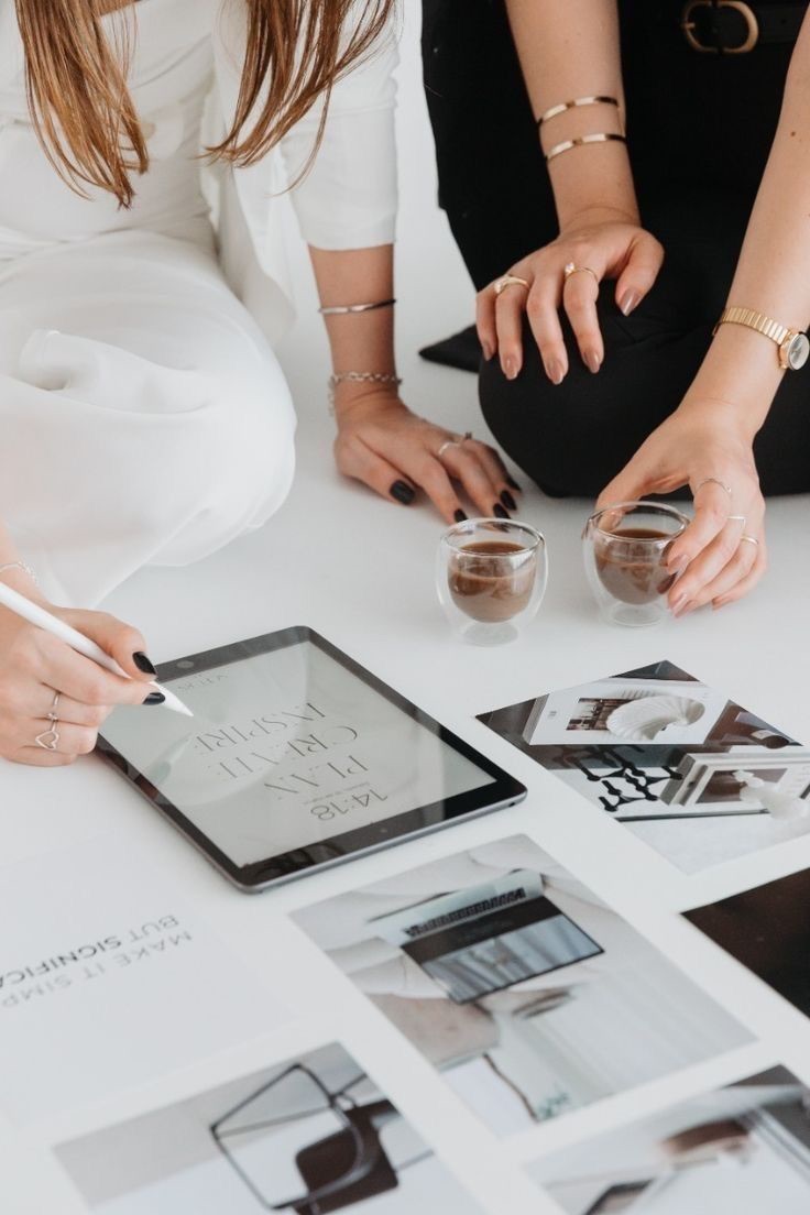 Two people planning together with a tablet and printed photos